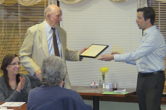 SNA President Dean Weinberg, right, awards a certificate of recognition to community activist Gil Mason.