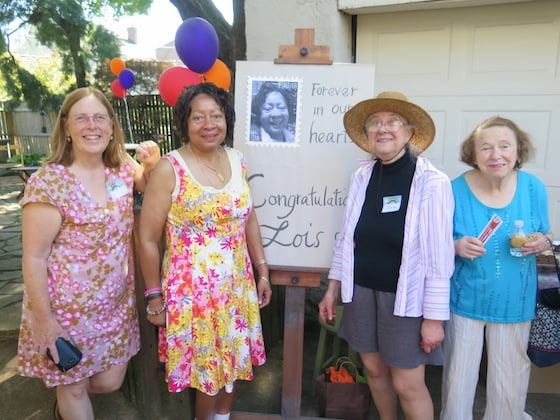 Lois J. Overton Wortham and friends gather at the sign expressing the feeling of her constituents.
