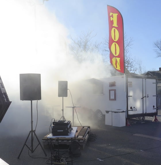The same banner flies above the smoke after the food truck caught fire and onlookers feared the propane tanks inside would explode. They didn't and the fire department got everything under control.